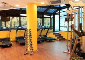a gym with rows of tread machines and a yellow pole at Apart-hotel Bourbon São Paulo Ibirapuera Convention Hotel in Sao Paulo