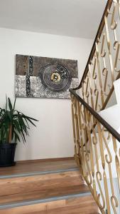 a staircase with a painting on the wall and a plant at Haus Lisa 