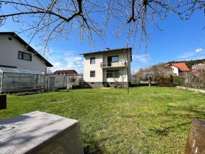 a large yard with a white house in the background at Haus Lisa in Kroisbach