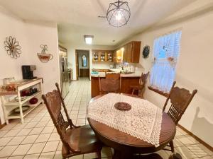 a dining room with a table and a kitchen at Cozy house centrally located close to everything in NWA in Springdale