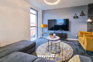 a living room with a couch and a tv at Luxury 2bdr Flat With Canal View & Free Parking in Manchester