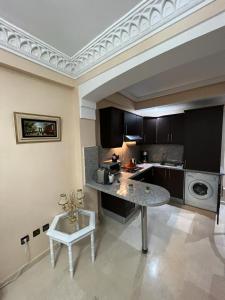 a kitchen with a counter and a table in it at Luxury apartment 3 in the heart of Gueliz, Wifi, Pool in Marrakech