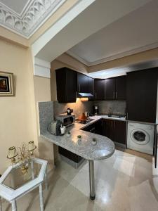 a kitchen with a counter and a table in it at Luxury apartment 3 in the heart of Gueliz, Wifi, Pool in Marrakech