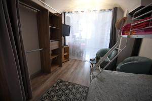 1 dormitorio con litera y TV en Le trio des alpes en Mont-Dauphin