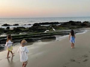 皮烏拉的住宿－Casasol_mancora，三名儿童在海边散步
