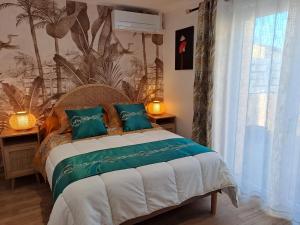a bedroom with a bed with a tropical wallpaper at L''indochine in Perpignan