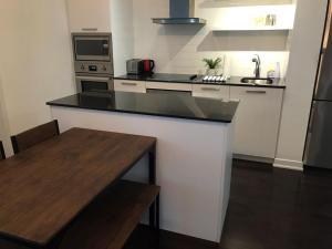 a kitchen with a black counter top in a room at Home Away From Home in Toronto