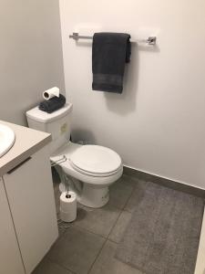 a bathroom with a white toilet and a sink at Home Away From Home in Toronto