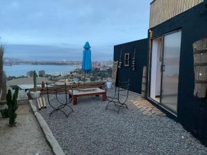 a patio with a table and chairs and an umbrella at Loft la herradura in Coquimbo