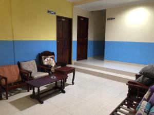 a room with chairs and a table in a room at Hotel Sekawan in Jodoh