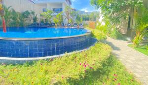 a swimming pool in a yard next to a house at Solaluna Beach Homestay in Amed