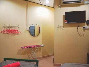 a room with a basketball hoop and a tv at Lagenda Resthouse Langkawi in Pantai Cenang