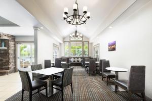 a dining room with tables and chairs at Residence Inn Des Moines West at Jordan Creek Town Center in West Des Moines