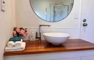 a bathroom with a bowl sink and a mirror at Lakeside Retreat in Cromwell