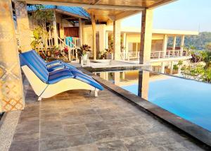 a house with a swimming pool and a patio at Nusa View in Nusa Lembongan