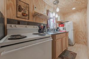 a kitchen with a white stove and a sink at Tiny House at Buffalo River Lodge in Saint Joe