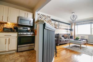 a kitchen with a stove and a living room at Brooklyn Double Decker in Brooklyn