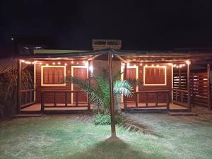 a house with lights on the front of it at night at Pequeñas Diablitas in Punta Del Diablo