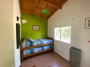 a bedroom with a bunk bed and a window at Cabañas Monte Hermoso in Monte Hermoso