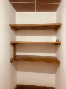 a stairwell with wooden shelves in a room at Hostal Raíces de mi Pueblo in Suchitoto