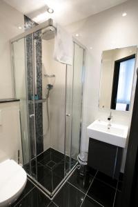 a bathroom with a shower and a sink and a toilet at Great St Helen Hotel in London