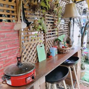 a table with a pot and some plants on it at Ban Kru Ae mixed dorm in Ban Don Muang (1)
