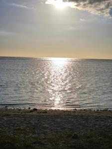 una spiaggia con il sole che riflette sull'acqua di AP Villa Tourist Residence 16467 a Flic-en-Flac