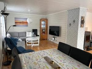 a living room with a couch and a table at Holiday home Korsfjorden in Komagfjord