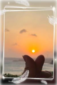 a picture of a sunset in a glass box at 南灣陽光皮小妞 Pii hostel in Nanwan