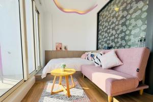 a living room with a couch and a table at 南灣陽光皮小妞 Pii hostel in Nanwan