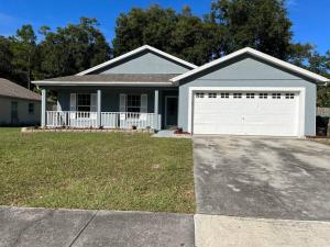 a house with a white garage door in a yard at Beautiful Modern 3 BR House - Downtown Orlando in Orlando