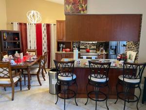 a kitchen with a table and chairs and a kitchen with a counter at Beautiful Modern 3 BR House - Downtown Orlando in Orlando