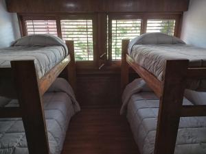 2 łóżka piętrowe w pokoju z 2 oknami w obiekcie Casa Roble w mieście Barraquero