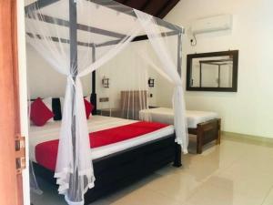 a bedroom with a canopy bed and a mirror at Walawa Reach hotel in Udawalawe +19 photos