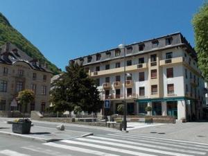 a building with a crosswalk in front of a street at Appartement Bagnères-de-Luchon, 3 pièces, 4 personnes - FR-1-313-228 in Luchon