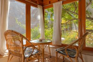 two chairs and a table in front of a window at Garkone Homestay in Dah