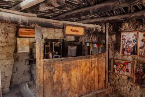 an old wooden door in a room with posters at Garkone Homestay in Dah +20 photos