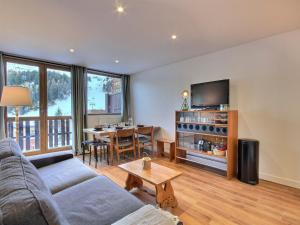 a living room with a couch and a table at Très bel appartement rénové pour 5 pers à La Plagne - FR-1-455-248 in La Plagne Tarentaise