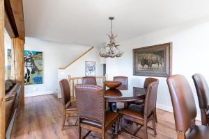 a dining room with a table and chairs at Saddle Ridge V2 by Moonlight Basin Lodging in Big Sky