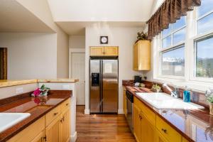 a kitchen with a stainless steel refrigerator and wooden counters at Saddle Ridge V2 by Moonlight Basin Lodging in Big Sky +23 photos