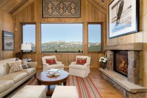 a living room with a fireplace in a cabin at 5 Bandit Way by Moonlight Basin Lodging in Big Sky