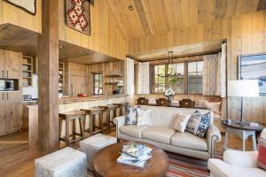 a living room with a couch and a table at 5 Bandit Way by Moonlight Basin Lodging in Big Sky