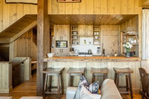 a kitchen with a bar and a couch in a room at 5 Bandit Way by Moonlight Basin Lodging in Big Sky