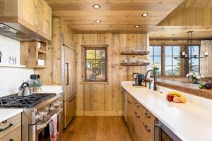 a kitchen with wooden walls and wooden flooring at 5 Bandit Way by Moonlight Basin Lodging in Big Sky