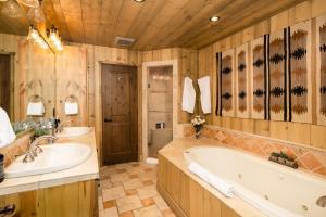 a large bathroom with two sinks and a tub at 5 Bandit Way by Moonlight Basin Lodging in Big Sky