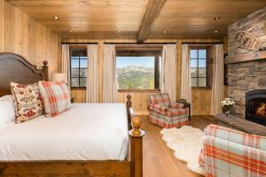 a bedroom with a bed and a fireplace at 5 Bandit Way by Moonlight Basin Lodging in Big Sky +18 photos