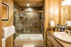 a bathroom with a tub and a sink at 5 Bandit Way by Moonlight Basin Lodging in Big Sky