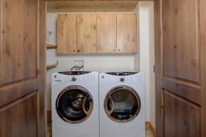 a laundry room with a washer and dryer at 5 Bandit Way by Moonlight Basin Lodging in Big Sky