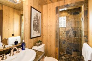 a bathroom with a shower and a sink and a toilet at 5 Bandit Way by Moonlight Basin Lodging in Big Sky