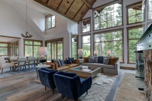 a living room with a lot of windows at 6 Diversion Lane by Moonlight Basin Lodging in Big Sky +33 photos